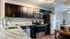 Kitchen with stainless steel appliances and black cabinets