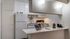 Alturas Andrews Kitchen Furnished with White Appliances and White Cabinetry