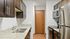 Arrive 4301 Kitchen with Granite Countertops and Brown Cabinetry