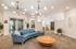 Arrive Chadds Ford Lounge with Large Sofa and Modern Light Fixtures