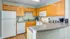 Kitchen with white appliances and wood cabinets