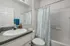The Social Seminole Bathroom with Granite Countertops and White Cabinets