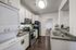 The Social Seminole Kitchen with Granite Countertops and Black Appliances