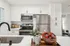 Arrive Rolling Oaks Kitchen with White Countertops and Stainless Steel Appliances