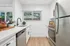 Arrive Rolling Oaks Kitchen with White Countertops and Stainless Steel Appliances