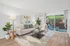 Arrive Rolling Oaks Living Room with Large Sliding Glass Doors and Natural Lighting