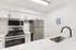 Arrive Laurie Lane Kitchen with White Countertops and Stainless Steel Appliances