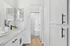 Arrive Santa Clarita Bathroom with White Cabinetry and Black Appliances