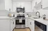 Arrive Santa Clarita Kitchen with White Cabinetry and Black Appliances