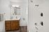 Alturas Vose Townhomes Bathroom with Wooden Cabinets and Bright Light Fixtures