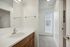 Alturas Vose Townhomes Bathroom with Wooden Cabinets and Modern Light Fixtures