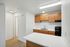 Alturas Vose Townhomes Kitchen with Wooden Cabinets and White Countertops