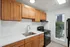 Alturas Vose Townhomes Kitchen with Wooden Cabinets and White Countertops