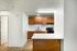 Alturas Vose Townhomes Kitchen with Wooden Cabinets and White Countertops