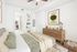 Tranquil modern bedroom with stylish decor, soft green accents, and a walk-in closet.