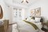 Bright and stylish bedroom with modern decor, featuring a comfortable bed, abstract wall art, and a cozy carpet.