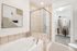 Elegant bathroom featuring a large bathtub, glass-enclosed shower, and a spacious walk-in closet.