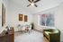 Chic and modern home office with glass desk, wooden decor, and large window view.