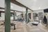 Modern fitness center with cardio machines, weight bench, and sleek wood accents.