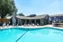 Inviting outdoor pool area with lounge chairs and modern clubhouse.