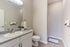 Elegant bathroom featuring modern fixtures, sleek countertop, and soft lighting.