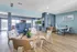 Modern communal area with stylish chairs, wooden flooring, and vibrant decor at The Social.