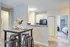 Contemporary dining area with a stylish table set and modern kitchen in a cozy apartment.
