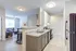 Bright and airy kitchen with modern appliances and open living area featuring cozy furnishings.