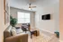 Inviting living room with stylish grey sofas, modern decor, and a wall-mounted TV.