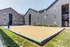 Inviting volleyball court in front of contemporary apartment buildings.