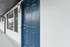 Stylish blue door entrance with a contemporary design and large window.