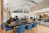 Elegant open-concept living area with a spacious dining table, modern kitchen, and comfortable lounge seating.