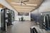 Modern gym with high-end equipment, sleek design, and spacious workout area.