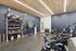 Well-equipped gym featuring exercise bikes and a variety of fitness accessories under stylish lighting.