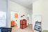 Stylish apartment interior featuring a cozy corner with a dresser, mirror, and partial view of a bathroom and study area.
