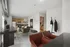 Modern open-plan apartment with a stylish kitchen, cozy living area, and sleek workspace.