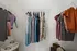Elegant walk-in closet featuring neatly arranged dresses and colorful garments on hangers.