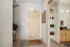 Welcoming apartment entryway with modern decor and a glimpse of a stylish bathroom.