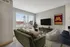 Chic urban living room with modern furnishings, large window view, and stylish decor.