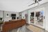 Arrive 800 Penn Spacious Living Room with Fireplace, and Sliding Glass Doors Leading to Balcony.