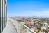 Stunning cityscape from a high-rise balcony with clear blue skies.