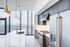 Luxurious kitchen with modern appliances, sleek cabinetry, and panoramic city views.