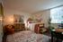 Inviting bedroom with desert-inspired decor, featuring a comfortable bed, warm lighting, and stylish accents.