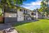 Beautiful two-story apartment complex with balconies and lush greenery.