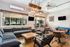 Chic lounge area with modern sofas, wooden table, and contemporary lighting, perfect for relaxation and socializing.