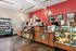 Inviting cafe interior with modern decor, featuring a well-stocked counter and cozy atmosphere.