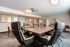 Sleek and modern conference room with luxurious leather chairs and a large wooden table.