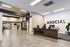 Contemporary lobby featuring a stylish reception desk with 'Hello' sign, modern decor, and inviting seating area.