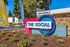 Vibrant entry sign at The Social Chico with garden landscaping and leasing banners.