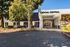 Inviting front view of Social Central with modern architecture and lush greenery.